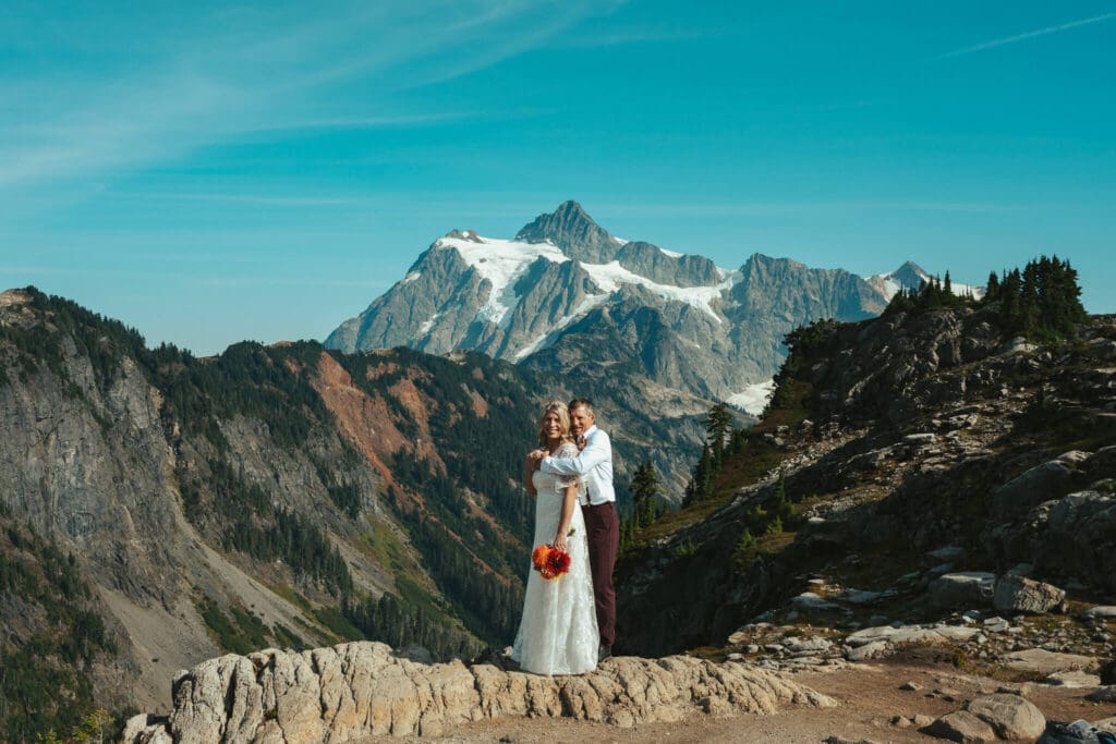 Couple embracing during an epic Artist Point elopement with dramatic North Cascades mountain scenery.