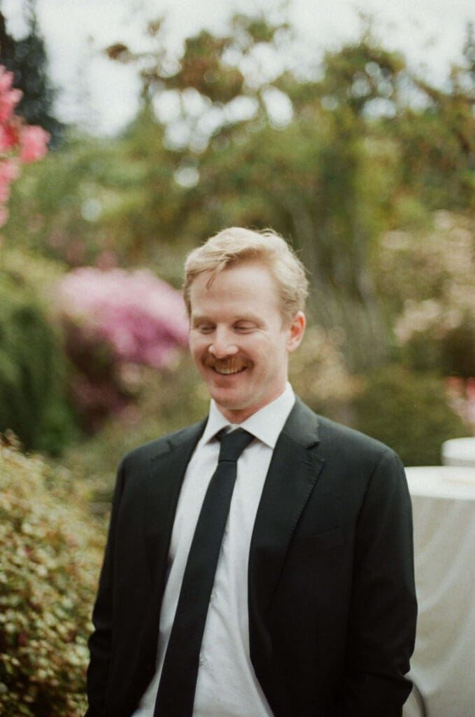 Groom portrait photographed on color film at a Shoreline Washington backyard wedding using documentary film photography.