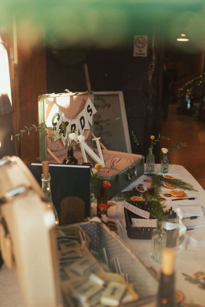 Wedding detail table with vintage decor, dried citrus, and guestbook items at Floral Hall in Everett, WA.