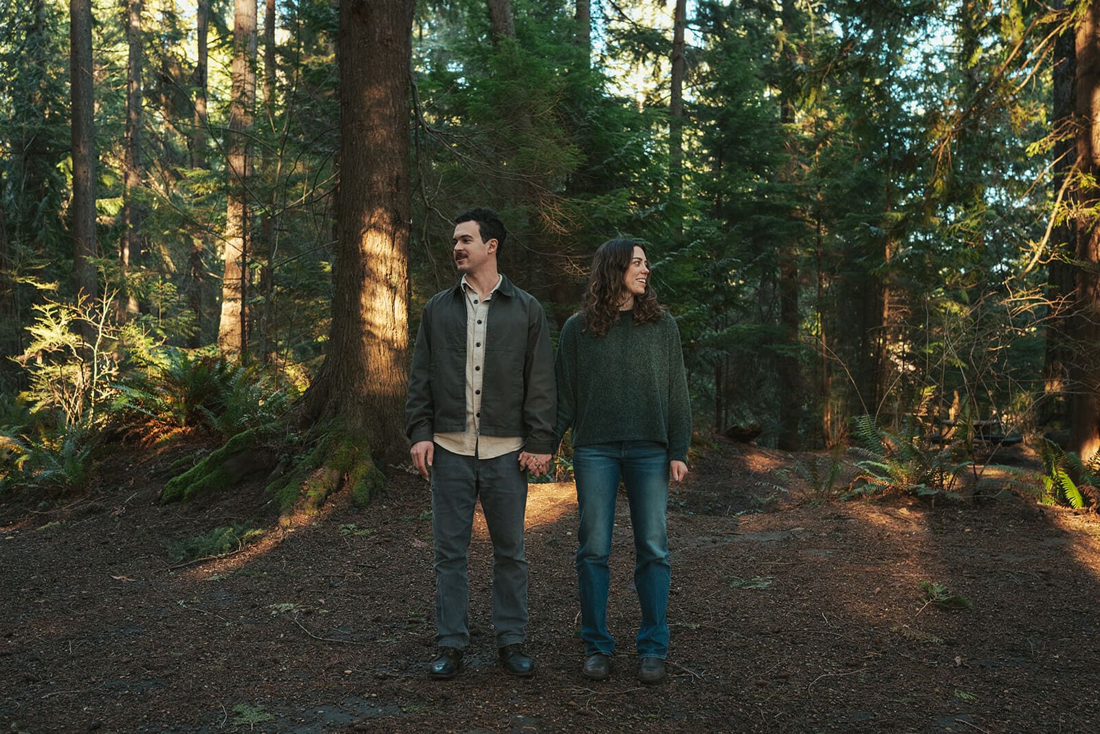 Evergreen forest engagement portraits with a romantic, vintage-inspired feel at Flowing Lake County Park in Snohomish County.