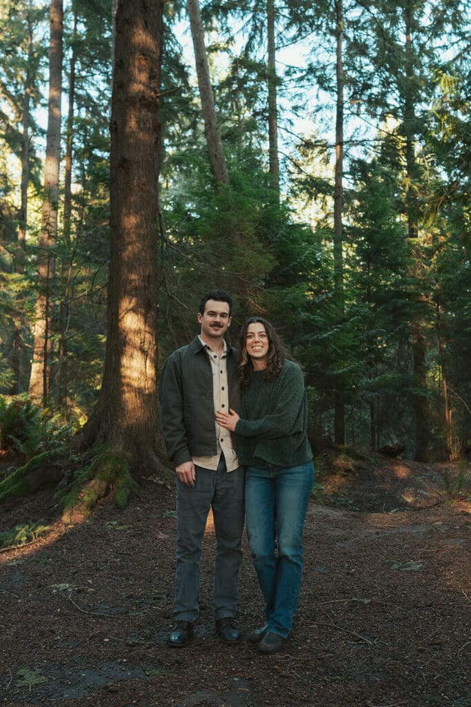 Romantic engagement portraits in a Pacific Northwest forest at Flowing Lake County Park in Snohomish County, Washington.