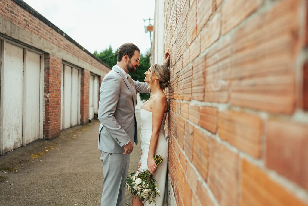 The couple shares a quiet moment beside a brick wall in an alley in downtown Snohomish.