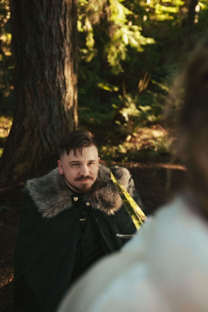 Groom smiling during a first look in the forest on a winter wedding day near Floral Hall in Everett, WA.